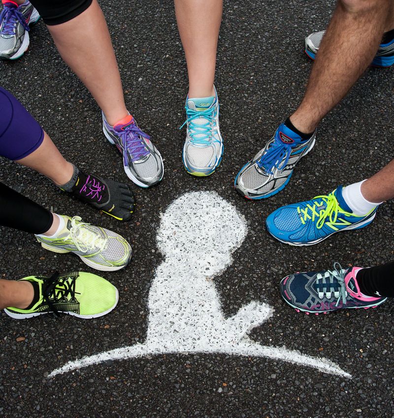 photo of feet clad in running shoes making a circle around a St. Jude child logo