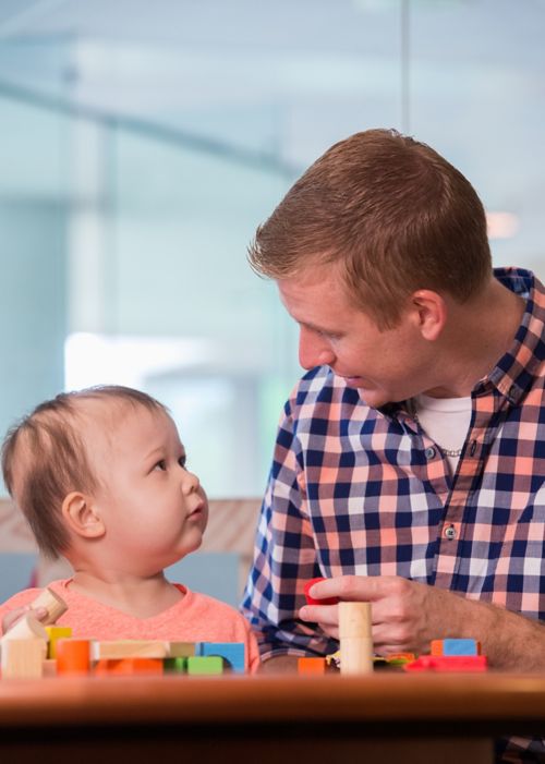 Parent and infant playing with blocks