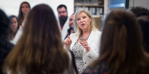 Photo of Stacey Schultz-Cherry, PhD, talking to group of students