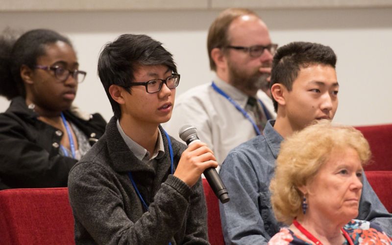 Image of student with microphone asking question