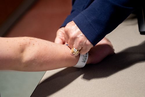 Registration placing armband on patient