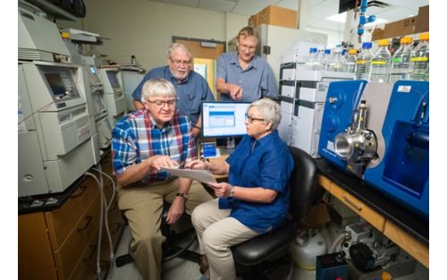 Picture of four scientists in a lab