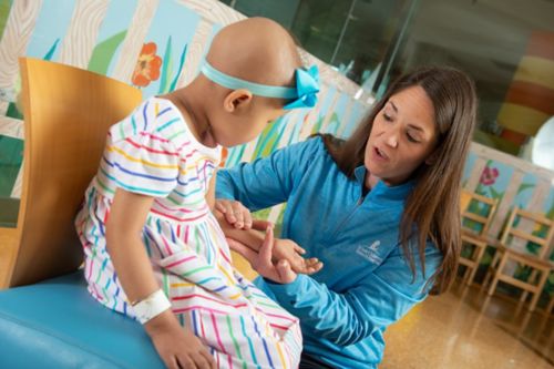 Female child patient working with child life specialist