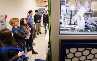 Photo of students visiting robots in cheical biology
