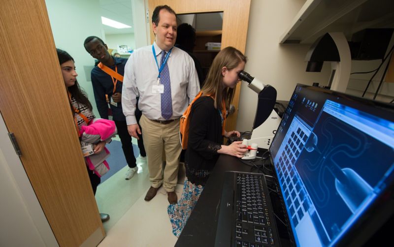 Photo of Chuck Gawad, MD, PhD showing students microscopic images