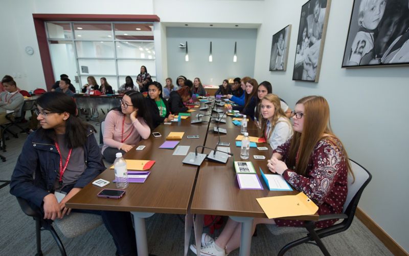 Photo of students sitting at table.