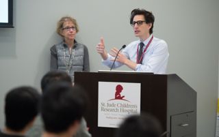 Photo of Josh Wolf, MBBS, leading a presentation on precision medicine.