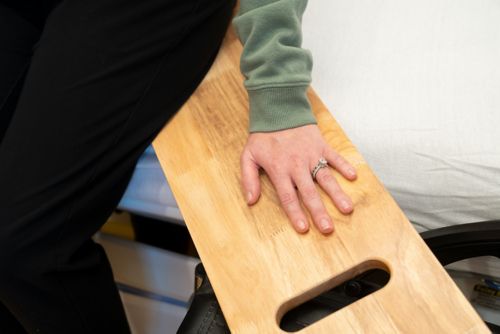 Have your child put one hand on the sliding board to help with balance.