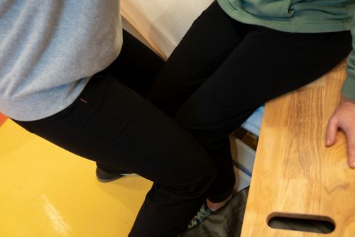  Put your knees in front of your child’s knees to keep them from sliding forward.