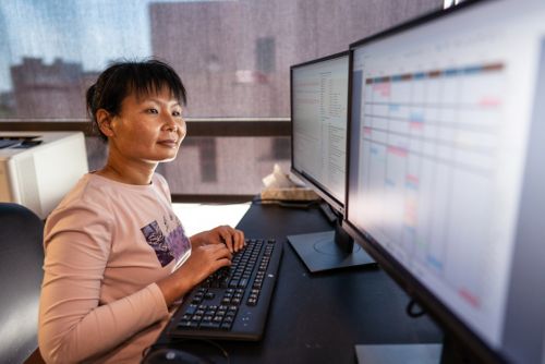 image of woman looking at computer screens