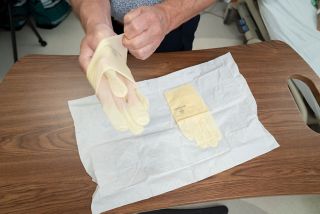 Keep your palm facing up while putting on a sterile glove.
