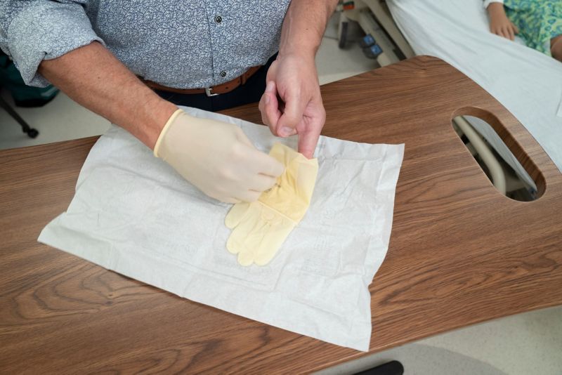 Putting on the second sterile glove