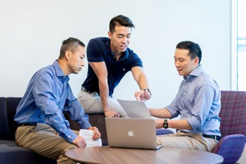 Wenjian Yang, Shawn Lee, and Jun J Yang sitting while having a discussion