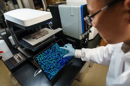 photo of man operating lab machine