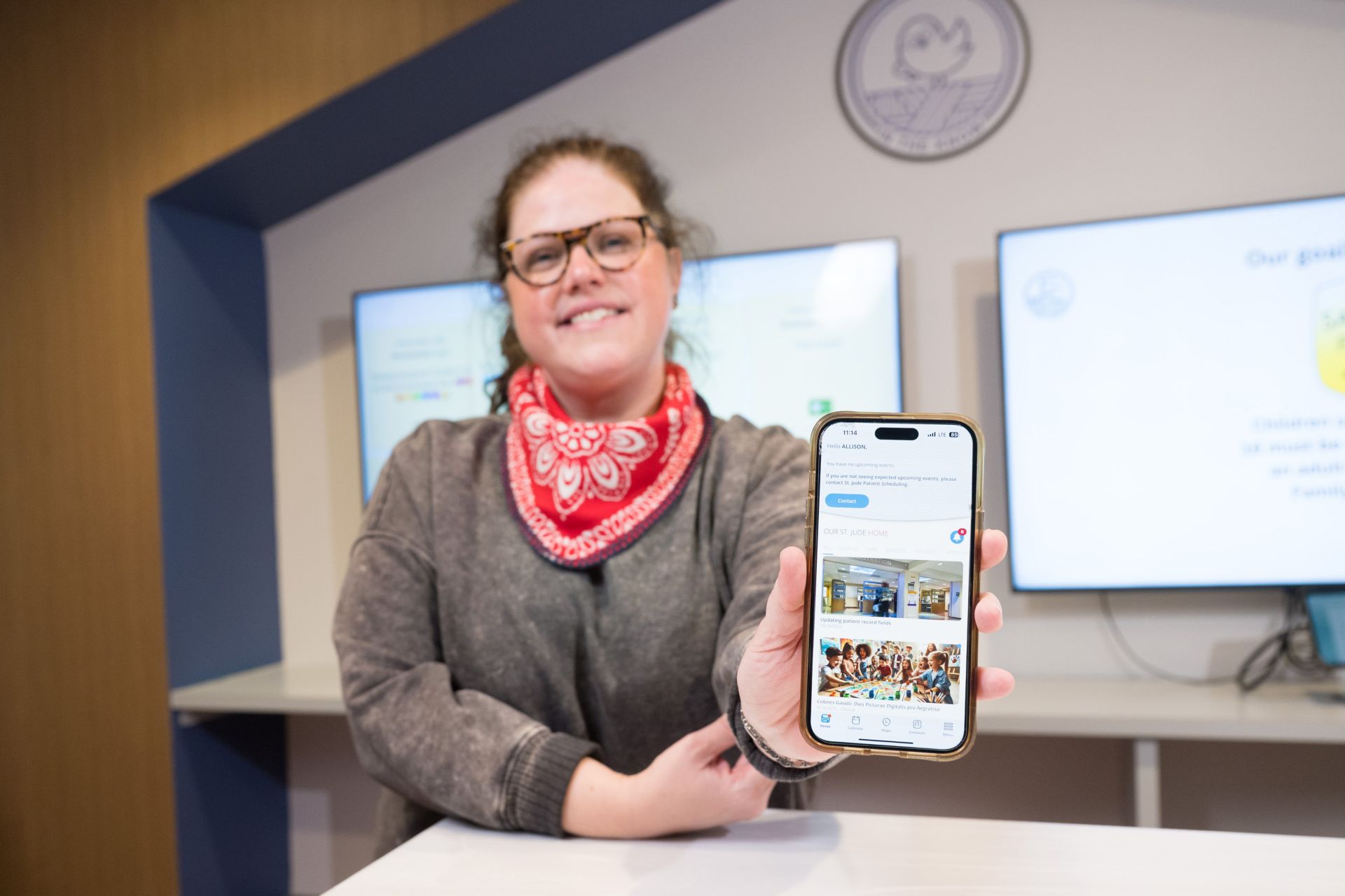 Caitlin Maley holding up a mobile phone