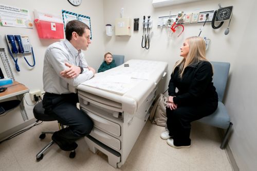 Seth Karol speaking with a mother and her son
