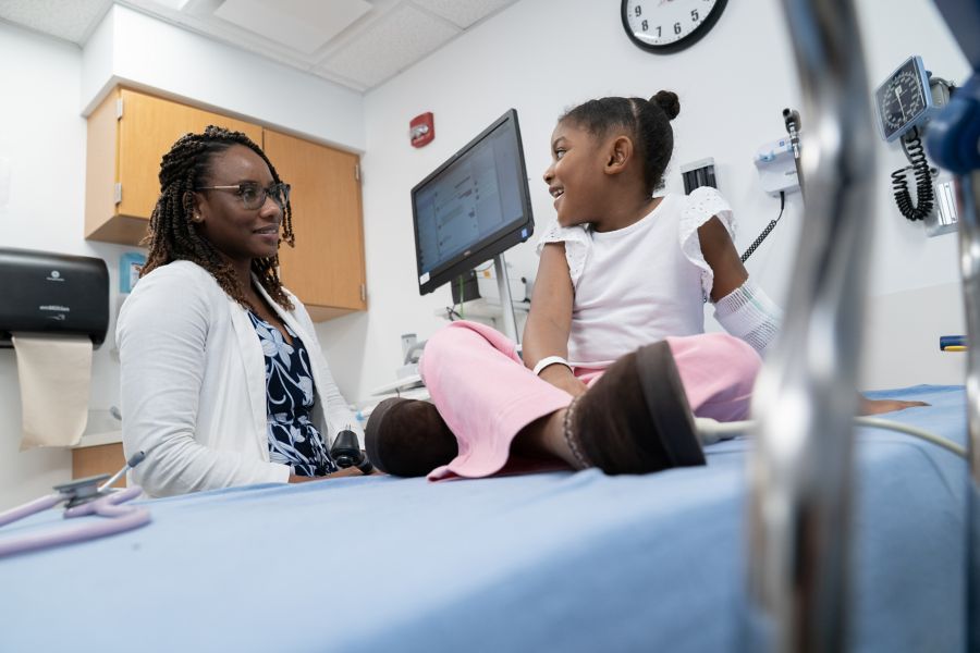 A doctor talking with child patient