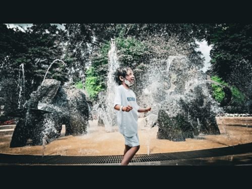 Maria Tangonan dances in an outdoor water fountain