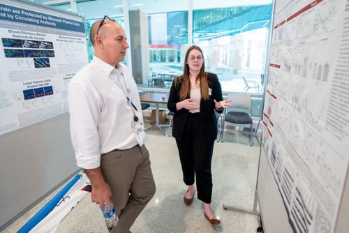 Two people looking at a poster