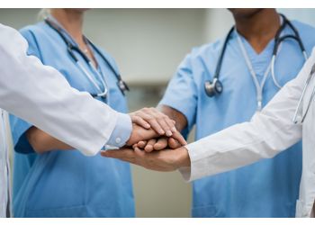 image of people placing hands together