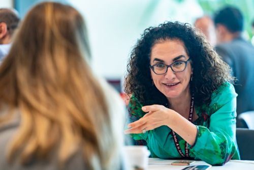 Arzu Onar-Thomas talking to student