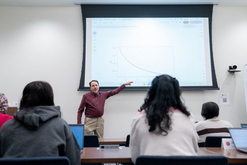 Students in a classroom with Stan Pounds