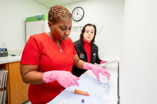 Two women preparing medication