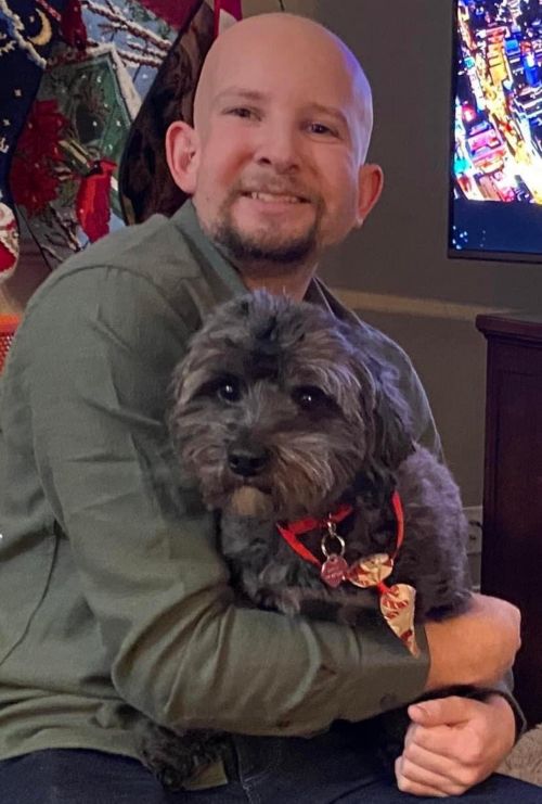 Photo of Garrett holding his dog