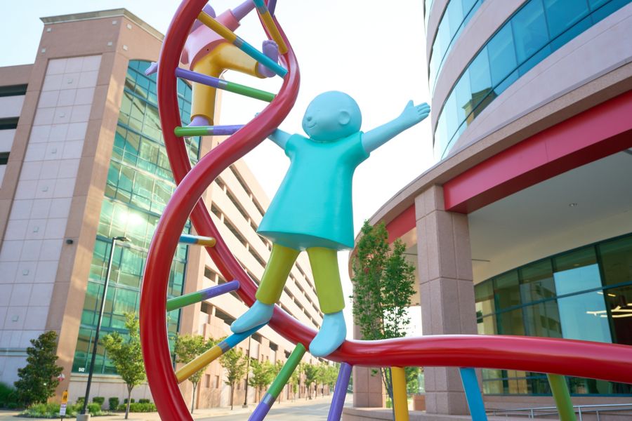 Sculpture of child climbing DNA double-helix