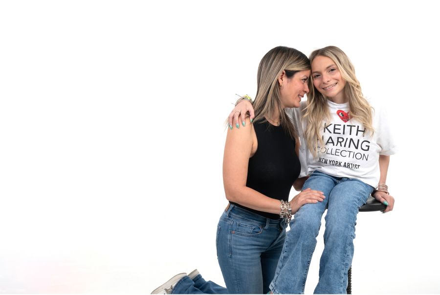 Mother and daughter pose in studio photoshoot with white background