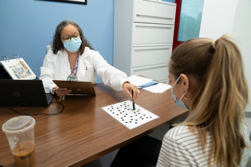 A patient doing a thinking skills exam