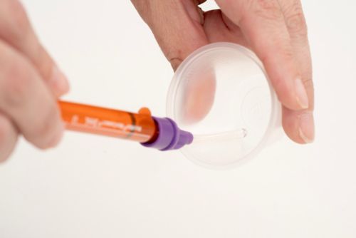 A DoseMate attachment can be used with the ENFit syringe to draw up medication from a dispensing cup.