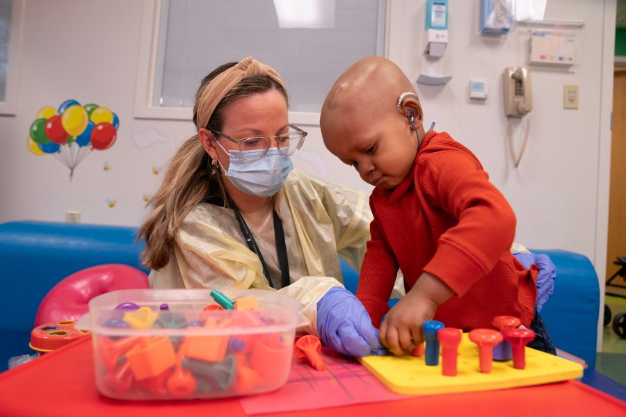 A child life specialist playing with child cancer patient