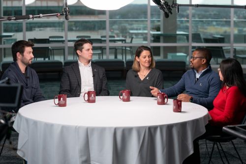 photo of five people sitting around a table