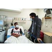 Doctor talking to patient in hospital room