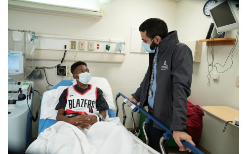 Doctor talking to patient in hospital room