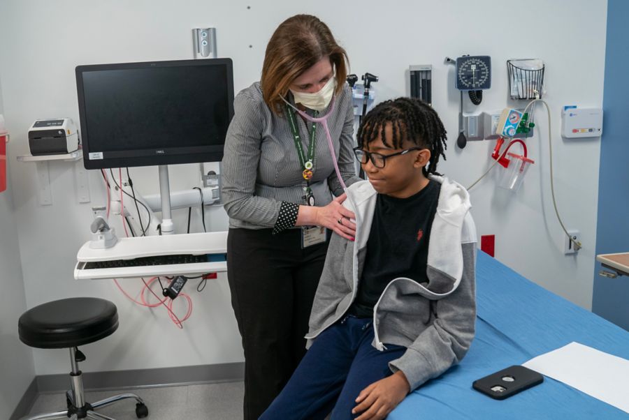 Doctor listening to male patient's heartbeat with stethoscope