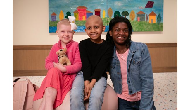 Three female patients pose in Family Commons