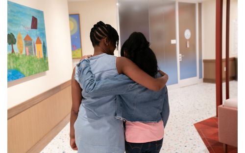 Mother and daughter walk through family commons