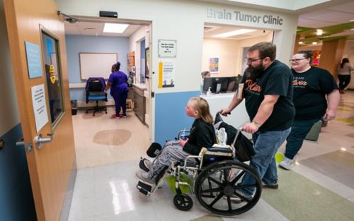 Girl in wheel chair meeting doctor