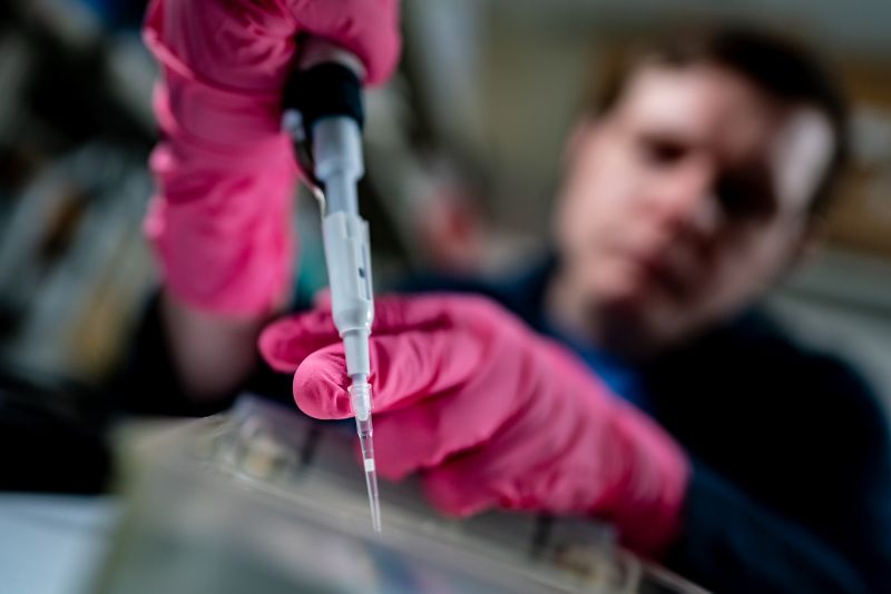 A St. Jude scientist pipettes in the lab.