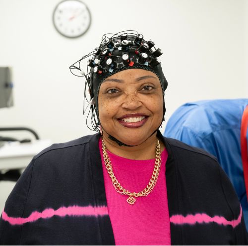 A smiling person in a medical setting