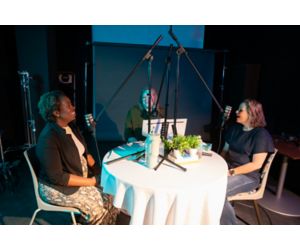 Three women conversing at table