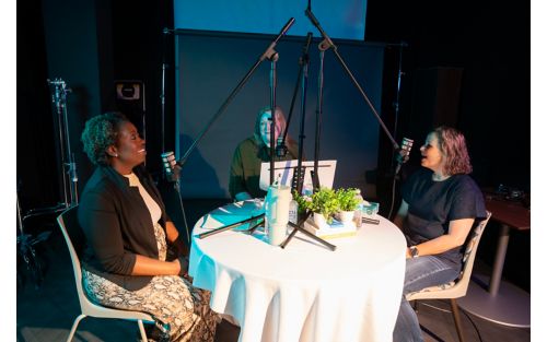 Three women conversing at table