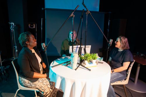 Three women conversing at table