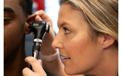 image of medical professional looking into patient's ear