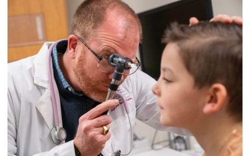 image of doctor looking into child's eye
