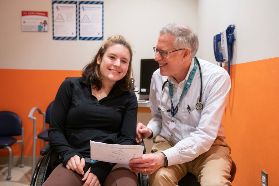 An image of a patient and a doctor looking over paperwork