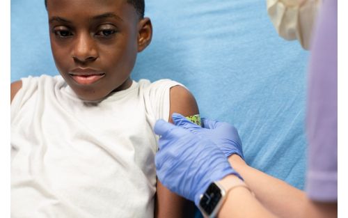 Child gets bandaid put on arm by nurse