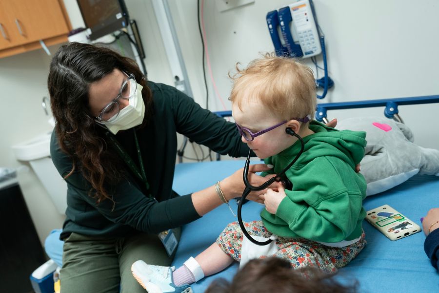 Doctor listens to baby's heart with stethoscope